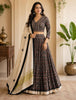 Model wearing a dark patterned lehenga choli with a cream dupatta from Aan Silk House.