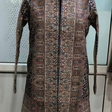 A mannequin wearing a long, patterned jacket with a high collar and long sleeves.