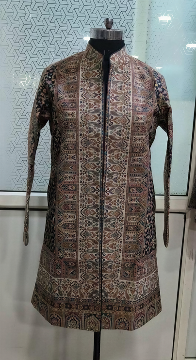A mannequin wearing a long, patterned jacket with a high collar and long sleeves.