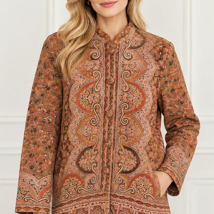 Kani Jamawar women's short winter jacket, rust paisley, front view on model, hand in side pocket